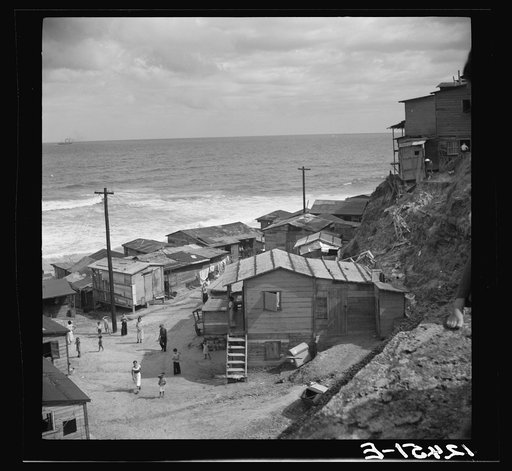 Untitled photo, possibly related to: View of a portion of the workers' quarter of La Perla from the old Spanish ramparts. San Juan, Puerto Rico