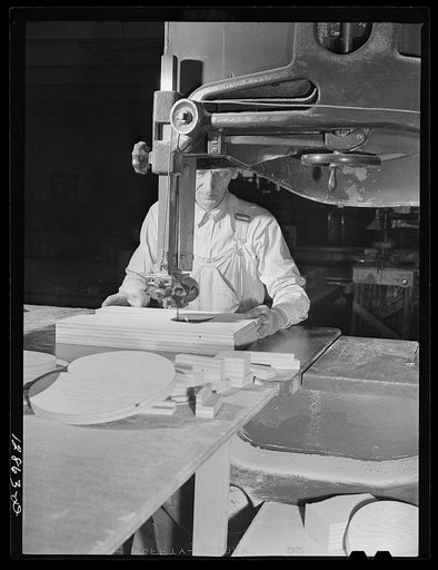 New York, New York. Preparing the defense bond sales photomural, designed by the Farm Security Administration, to be installed in the Grand Central terminal, in the shop of a contractor. Cutting out plywood letters used for the text
