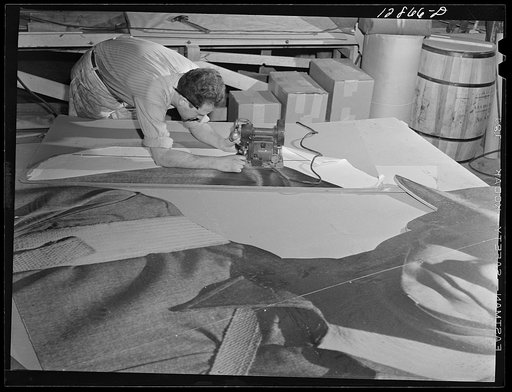 New York, New York. Preparing the defense bond sales photomural, designed by the Farm Security Administration, to be installed in the Grand Central terminal, in the shop of a contractor. Cutting out part of a large figure mounted on homosote board with a routing machine