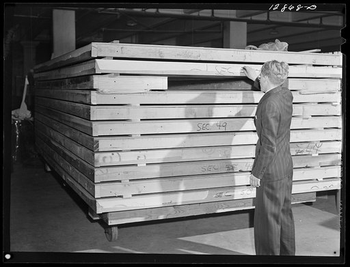 New York, New York. Preparing the defense bond sales photomural, designed by the Farm Security Administration, to be installed in the Grand Central terminal, in the shop of a contractor. Sections of one panel ready for installation