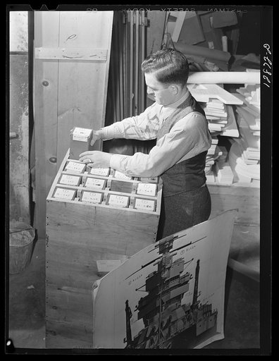 Washington, D.C. Preparing the defense bond sales photomural, to be installed in the Grand Central terminal, New York, in the visual unit of the Farm Security Adnministration. Packing finished print strips for one unit, keyed by code according to the dummy, for future assembly