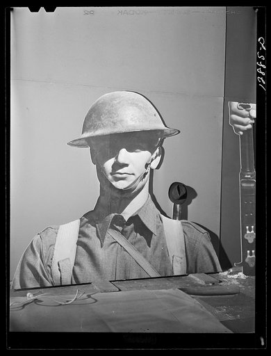 Untitled photo, possibly related to: New York, New York. Preparing the defense bond sales photomural, designed by the Farm Security Administration, to be installed in the Grand Central terminal, in the shop of a contractor. Cutting out part of a large figure mounted on homosote board with a routing 