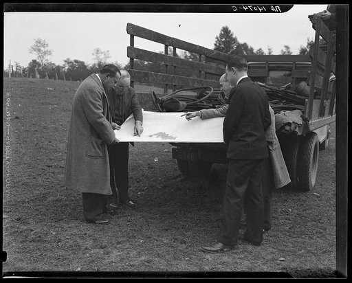 Untitled photo, possibly related to: Officials examining plan of Greenbelt, Maryland