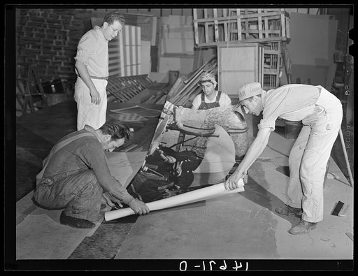 New York, New York. Preparing the defense bond sales photomural, designed by the Farm Security Administration Administration to be installed in the Grand Central terminal, in the shop of a contractor. Mounting the agricultural panel on homosote board with flour paste