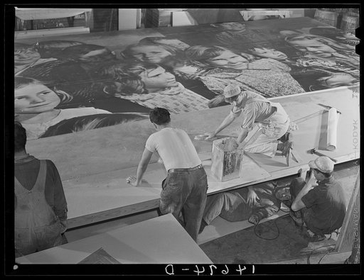 New York, New York. Preparing the defense bond sales photomural, designed by the Farm Security Administration, to be installed in the Grand Central terminal, in the shop of a contractor. Mounting the center panel on the homosote board with flour paste