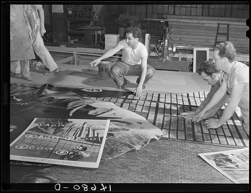 New York, New York. Preparing the defense bond sales photomural, designed by the Farm Security Administration, to be installed in the Grand Central terminal, in the shop of a contractor. Mounting the agricultural panel on homosote board with flour paste