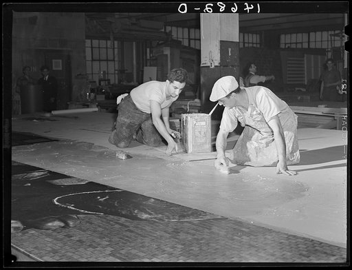 New York, New York. Preparing the defense bond sales photomural, designed by the Farm Security Administration Administration to be installed in the Grand Central terminal, in the shop of a contractor. Mounting a section on the industrial panel on homosote with flour paste
