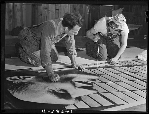 New York, New York. Preparing the defense bond sales photomural, designed by the Farm Security Administration, to be installed in the Grand Central terminal, in the shop of a contractor. Mounting one section of the industrial panel