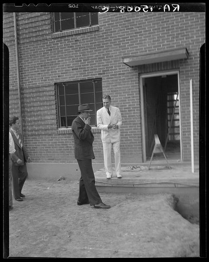 Resettlement Administrator, R.G. Tugwell and John L. Lansill inspecting houses under construction at Greenbelt, Maryland
