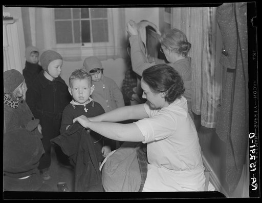Children being dressed before leaving nursery school for the day. Westmoreland Homesteads, Pennsylvania