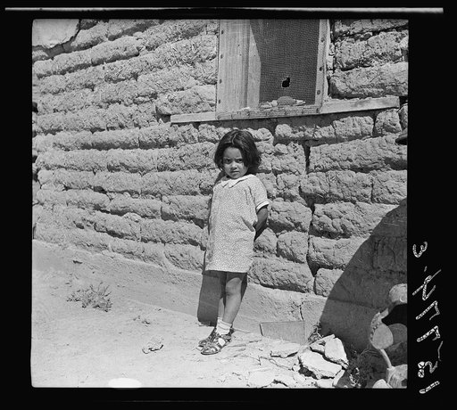 The mother said, "I keep her dressed nice every day because she is the only girl I've got." Great Western Sugar Company's beet sugar workers' colony at Hudson, Colorado