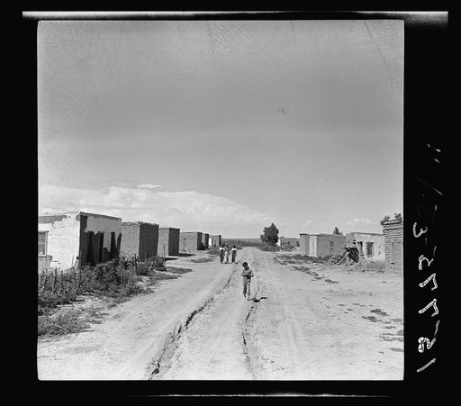 A colony of twenty adobe houses built by the inhabitants with materials supplied by the Great Western Sugar Company. Thirteen of the houses are used; seven are being unfit to use for inhabitation. In the thirteen houses live approximately fifty people. Being in the limits of an incorporated town (Hu