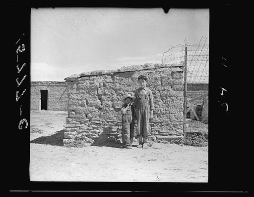 "This chicken house we're standing against is the only house here that doesn't leak. It's so low my pop can fix the roof." Great Western Sugar Company's beet sugar workers' colony at Hudson, Colorado