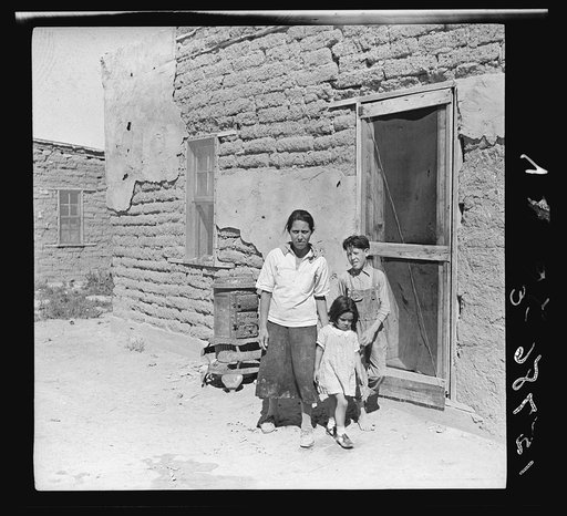 The mother said "I keep her dressed nice every day, because she is the only girl I've got." Great Western Sugar Company's beet sugar workers' colony at Hudson, Colorado