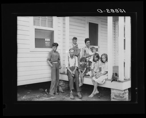 John Bunyan Locklear and family on porch of new home. Pembroke Farms, North Carolina