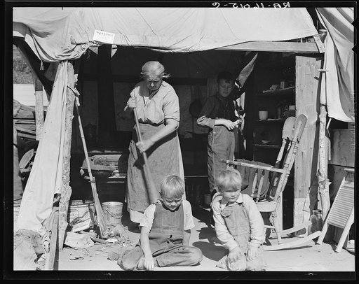 Aged woman with three of her twenty-two grandchildren, Kern county migrant camp, California