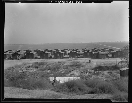Company housing for Mexican cotton pickers, showing the San Joaquin Valley in the background. South of Corcoran, California