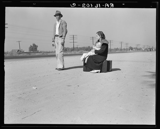 Young family, penniless, hitchhiking on U.S. Highway 99, California. The father, twenty-four, and the mother, seventeen, came from Winston-Salem, North Carolina, early in 1935. Their baby was born in the Imperial Valley, California, where they were working as field laborers