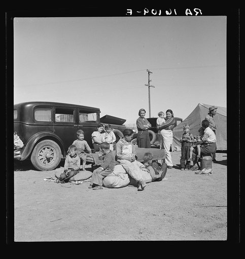 Four families, three of them related with fifteen children, from the Dust Bowl in Texas in an overnight roadside camp near Calipatria, California