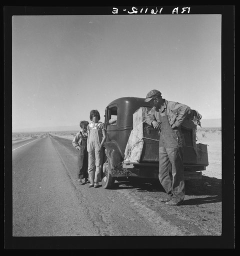 Oklahoma sharecropper and family entering California. Stalled on the desert near Indio, California