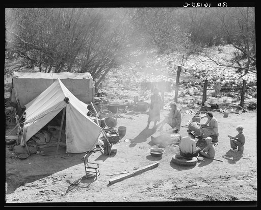 Two families, fifteen people, from Chickasaw, Oklahoma, camped by the roadside near Santa Maria, California. Heading for the pea harvest but stalled because they have no money to buy a trailer's license
