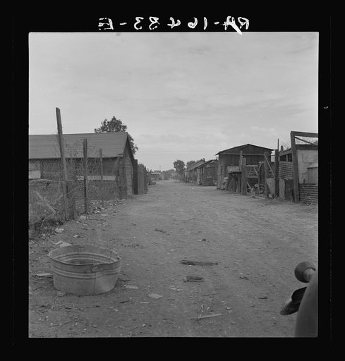 Slums of East El Centro, California. Typical of housing and sanitary conditions of Mexican field workers of the Imperial Valley. The houses rent for eight dollars a month