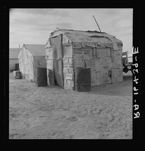 Migratory field worker's home on the edge of a pea field. The family lived here through the winter. Imperial Valley, California