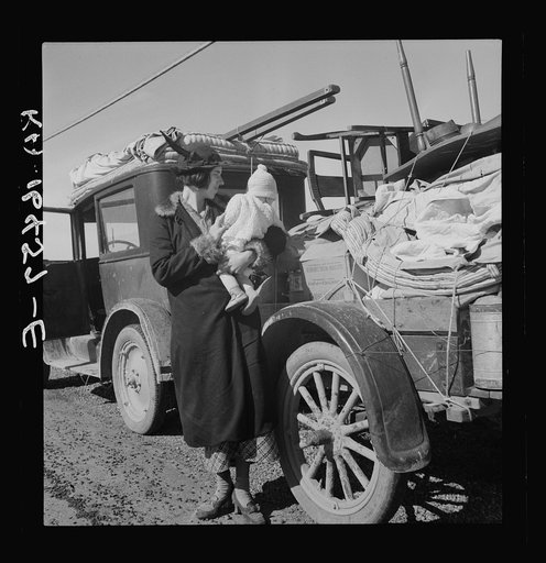 Mexican child. She helps tie carrots in the field. Coachella Valley, California