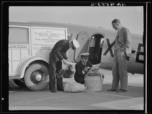 Plant quarantine inspectors examining baggage from Mexico for injurious insects. Glendale Airport, California