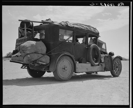 Family of nine from Fort Smith, Arkansas, trying to repair their car on road between Phoenix and Yuma, Arizona. On their way to try to find work in the California harvests