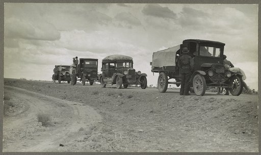 Three related drought refugee families stalled on the highway near Lordsburg, New Mexico. From farms near Claremore, Oklahoma. Have been working as migratory workers in Calfornia and Arizona, now trying to get to Roswell, New Mexico, for work chopping cotton. Have car trouble and pulled up alongside