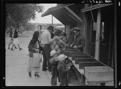 Untitled photo, possibly related to: Plant quarantine inspectors examining packages brought over the bridge between Juarez, Mexico and El Paso, Texas. Families and housewives returning to their homes in El Paso after their Saturday marketing in Juarez, where they benefit by the present rate of excha