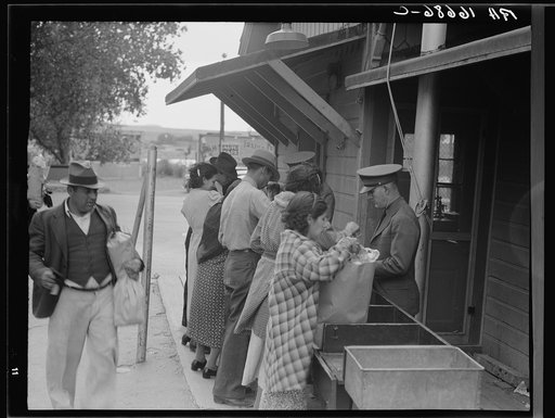 Plant quarantine inspectors examining packages brought over the bridge between Juarez, Mexico and El Paso, Texas. Families and housewives returning to their homes in El Paso after their Saturday marketing in Juarez, where they benefit by the present rate of exchange