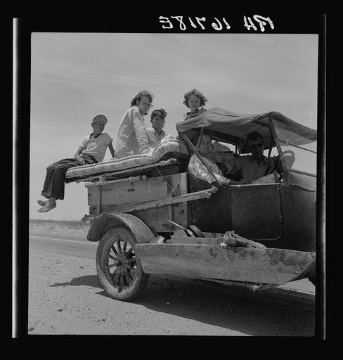 Migratory family traveling across the desert in search of work in the cotton at Roswell, New Mexico. U.S. Route 70, Arizona