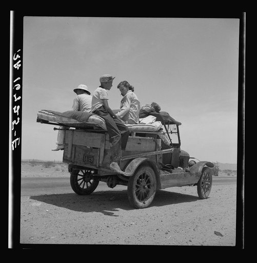 Migratory family traveling across the desert in search of work in the cotton at Roswell, New Mexico. U.S. Route 70, Arizona