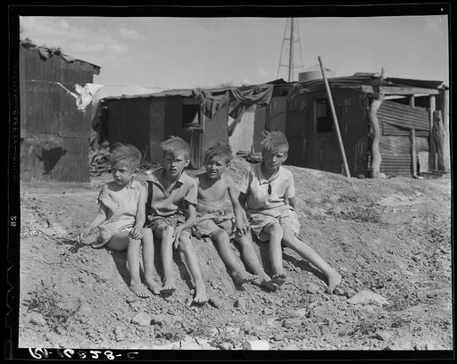 Children of migrant cotton field workers from Sweetwater, Oklahoma. Eight children in the family. Note the housing. Near Casa Grande project, Arizona
