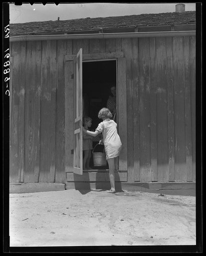Child of Texas sharecropper carrying water