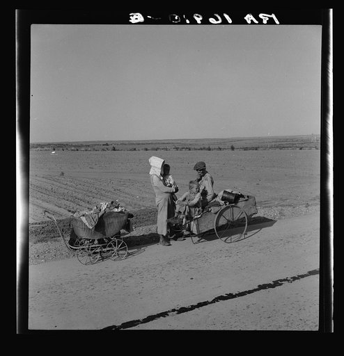 Flood refugee family near Memphis, Texas. These people, with all their earthly belongings, are bound for the lower Rio Grande Valley, where they hope to pick cotton. They are from Arkansas