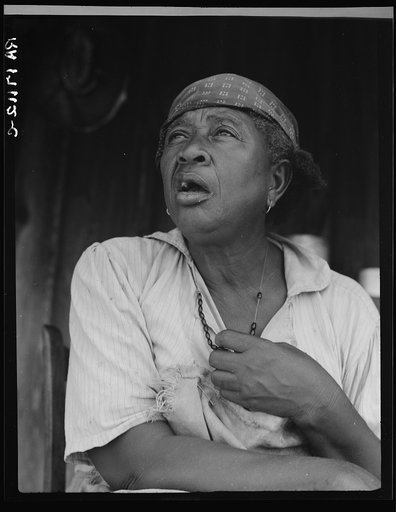 Fifty-seven year old sharecropper woman. Hinds County, Mississippi. Black beads hung between the breasts are good for heart trouble