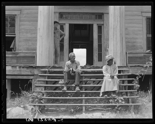 Ex-slave and wife on steps of plantation house now in decay. Greene County, Georgia