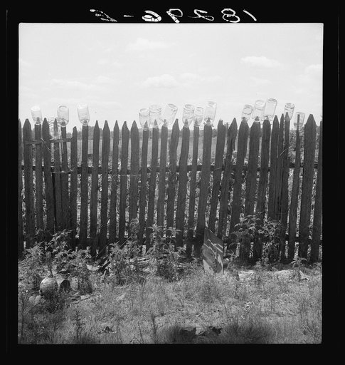 Untitled photo, possibly related to: Fruit jars being sterilized on old lady Graham's back fence in berry season. Near Conway, Arkansas. "We just gather and can peas, beans, berries, and sausage when we butcher the hogs in the winter. We put up seventy-five quarts of berries, sixty of beans, sixty o