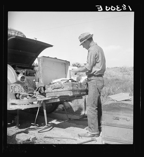 Car trouble on west side of Highway No. 33 in San Joaquin Valley. Formerly a California cowhand and roving laborer. Now with his wife, he follows the fruit. "My uncle homesteaded here sixty years ago. I'm lower on money than at any time." A veteran of the the AEF (American Expeditionary Forces) engi