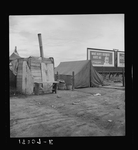 Squatter camp on the flat where families live during the orange picking season. Near Porterville, California