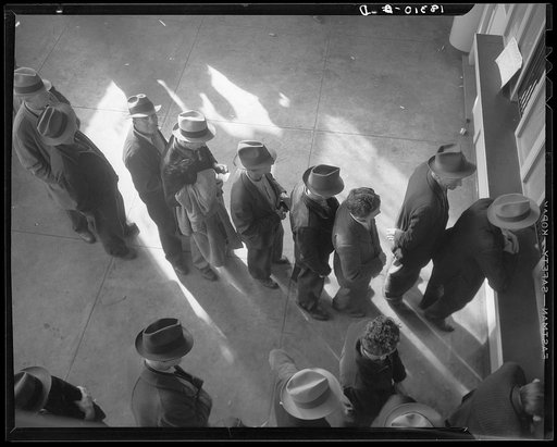 Unemployment benefits aid begins. Line of men inside a division office of the State Employment Service office at San Francisco, California, waiting to register for benefits on one of the first days the office was open. They will receive from six to fifteen dollars per week for up to sixteen weeks. C