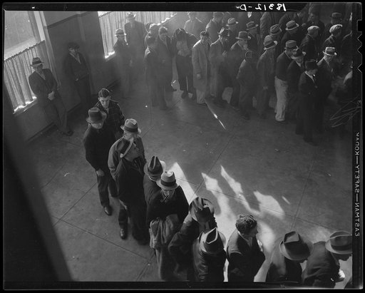 Unemployment benefits aid begins. Line of men inside a division office of the State Employment Service office at San Francisco, California, waiting to register for benefits on one of the first days the office was open. They will receive from six to fifteen dollars per week for up to sixteen weeks. C