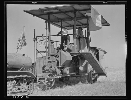 Combine harvester in California. Wheat field. San Joaquin Valley