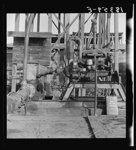 This pumping plant for irrigation is powered by a natural gas engine which operates on cost of about 1/2 the cost of electricity, Tulare County, California. Butane (natural gas in tanks) as a source of power on small farms is being developed by the Farm Security Administration Rural Rehabilitation P