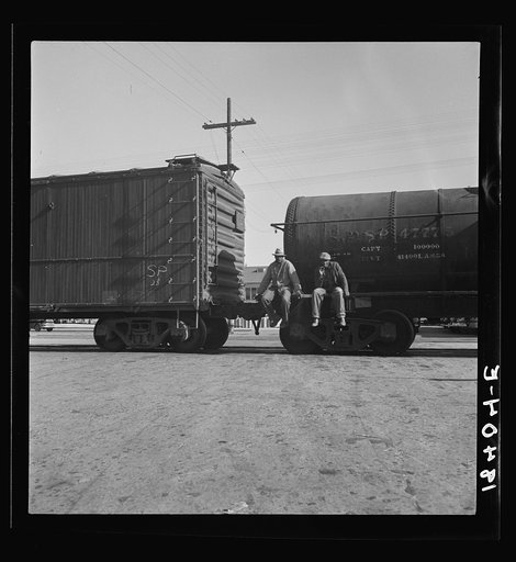 Colored itinerants on oil tank cars passing through Kingsbury, California