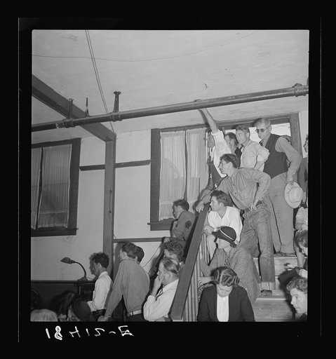 Listening to the speaker at the Conference to Aid Agricultural Organization during the cotton strike (Steinbeck Committee). Bakersfield, Kern County, California