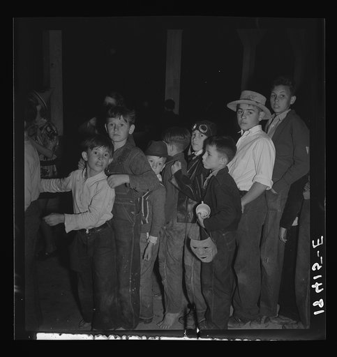 The children crowd and push to reach refreshments at Halloween party. Shafter migrant Camp, California